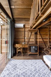 a bedroom with a bunk bed and a desk at Bali Cozy Bungalows, Nusa Dua Benoa in Nusa Dua