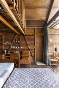 a bedroom with a bed and a wooden ceiling at Bali Cozy Bungalows, Nusa Dua Benoa in Nusa Dua