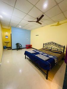 馬爾萬的住宿－Krupasagar Homestay，一间卧室配有一张床和吊扇