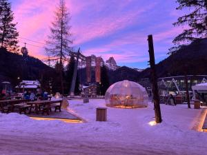 a snow covered area with a tent in the snow at Chalet Queen in Canazei