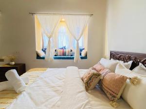 1 dormitorio con 1 cama grande y ventana en Jasmer Haveli, en Jaisalmer