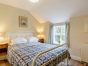 a bedroom with a bed and a window at 1 Penygroes in Penmachno