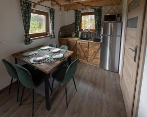 a kitchen and dining table in a tiny house at Leśny Kącik Zelwa in Zelwa