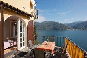 a balcony with a table and chairs and a view of a lake at Casa Bubu in Carmine