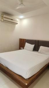 a bed in a room with a white mattress at hotelbhavya in Ahmedabad