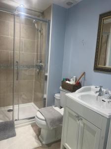 a bathroom with a shower and a toilet and a sink at Highcroft House in Corsham