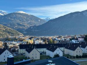 a small town with mountains in the background at Geräumiges sonniges Apartment mit Bergblick in Imst