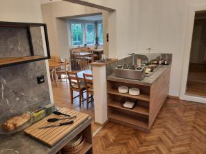 a kitchen with a counter with a sink and a table at Frühstückshaus Wunderland in Laa an der Thaya