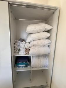 a bunch of towels are stacked in a closet at Carsija Life 2 in Avsallar