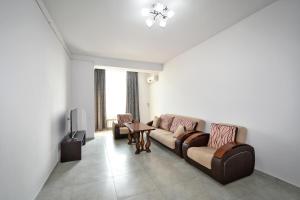 a living room with two couches and a tv at 2 Bedrooms Cozy Apartment In Center Of Yerevan in Yerevan