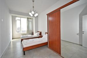 a room with two beds and a mirror at 2 Bedrooms Cozy Apartment In Center Of Yerevan in Yerevan