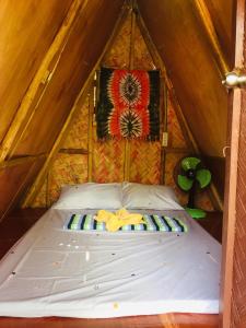 a bed in a room in a tent at SHALOM CAMP in El Nido