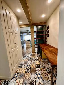 a hallway with a tile floor and a wooden table at Atuaire Home Vista Catedral de Burgos in Burgos