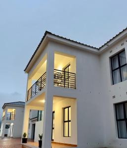 a white house with a balcony at 2nd on Strand in Cape Town