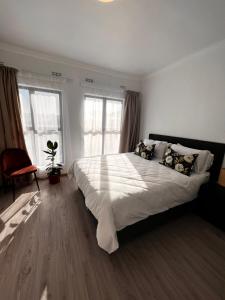 a bedroom with a large bed with white sheets and pillows at 2nd on Strand in Cape Town