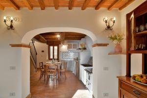 a kitchen and dining room with a table and chairs at La casina della Sassa in Sassa
