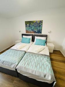 a bedroom with a large bed with blue pillows at Boutique Hotel Pohorje in Maribor