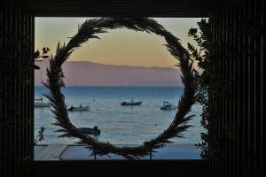 a round window with a view of the water with boats at STUDIO LES CALANQUES in Ajaccio