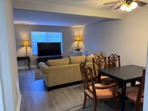 a living room with a couch and a table at 3 bedroom Town home in Charlotte