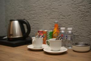 two cups of toothbrushes are sitting on a table at DAYMONTH HOTEL in Istanbul