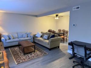 a living room with a couch and a table at 3 bedroom Town home in Charlotte