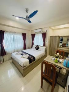 a bedroom with a bed and a ceiling fan at Hotel Janakpur Inn in Janakpur
