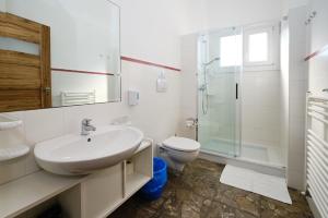 a bathroom with a sink and a toilet and a shower at Camere a Sud in Alliste