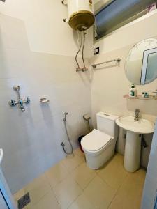 a bathroom with a toilet and a sink at Hotel Janakpur Inn in Janakpur