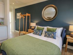 a bedroom with a large bed with a mirror on the wall at Loftus Old Bank in Loftus