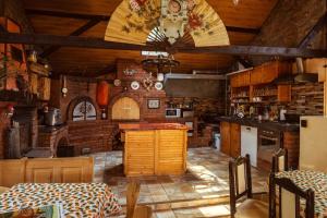a large kitchen with wooden walls and a ceiling at La Popica in Tîrnăveni