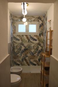 a bathroom with a sink and a toilet in a room at YOLE Affittacamere in Empoli