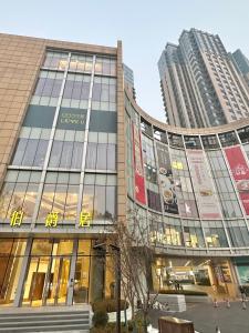 a building in a city with two tall buildings at ZHome-Count luxury apartment in Shanghai