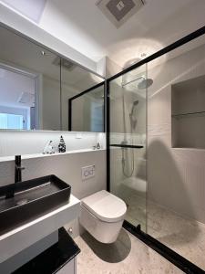 a bathroom with a toilet and a glass shower at ZHome-Count luxury apartment in Shanghai