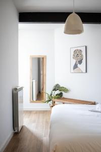 a bedroom with a bed and a mirror at Exclusive cozy Atocha apartment in Madrid