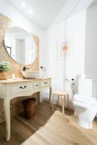 a bathroom with a sink and a toilet and a mirror at Exclusive cozy Atocha apartment in Madrid