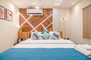 a bedroom with a large bed with a blue blanket at HOTEL SM PARADISE in Visakhapatnam