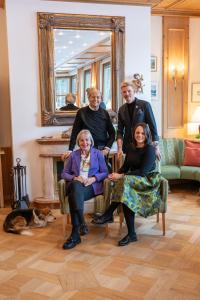 a group of people posing for a picture in a living room at Parkhotel Tristachersee in Lienz