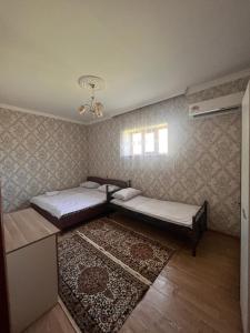 a bedroom with two beds and a rug at Miracle Gabala villa in Gabala