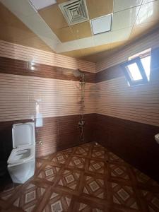 a bathroom with a toilet and a sink at Miracle Gabala villa in Gabala