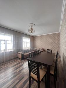 a dining room with a table and chairs and a bed at Miracle Gabala villa in Gabala