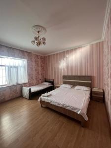 a bedroom with two beds and a window at Miracle Gabala villa in Gabala