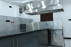 a kitchen with a large stainless steel counter top at Jaffna Inn in Jaffna