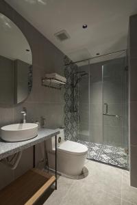 a bathroom with a toilet and a sink and a shower at Oceanhomes in Bien Ho