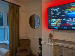 a living room with a flat screen tv on the wall at River's Edge in Stratford-upon-Avon