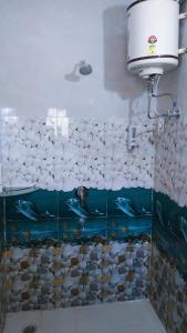 a bathroom with a fish tank on the wall at The Breeze Homestay in Shimla