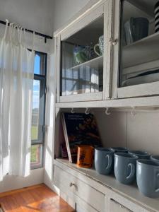 a cabinet with blue bowls sitting on a shelf at El Tambo - Hospedaje Rural in Navarro