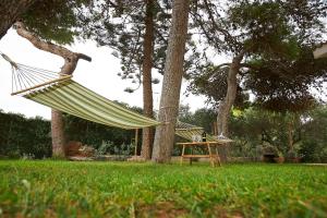 a hammock tied to a tree in a park at House on the sea garden in Marsala