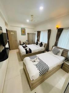 a hotel room with two beds and a television at Hotel Janakpur Inn in Janakpur