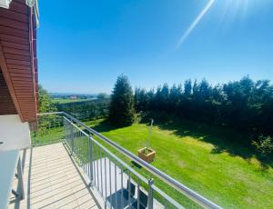 a balcony with a view of a grassy field at Friedrichshafen im Grünen genießen in Friedrichshafen