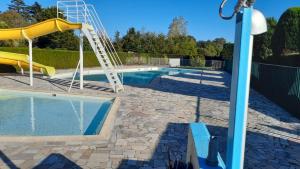 a swimming pool with a slide next to a swimming pool at Mobil home sur Carnac in Carnac